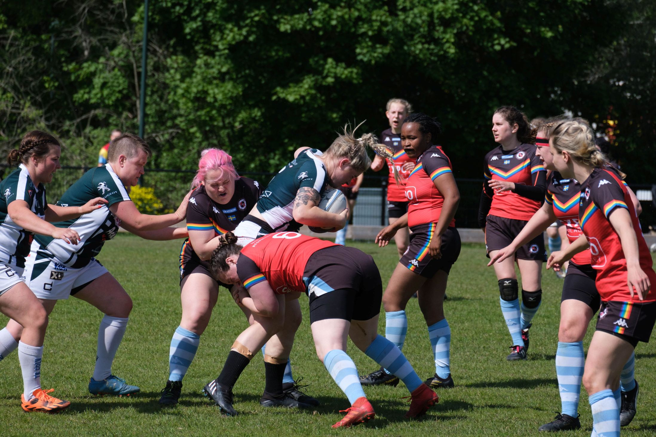 Stockholm Berserksers Rugby Club womens* inclusive team players tackling a player from Enköping